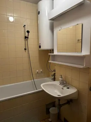 a bathroom with a sink and a tub and a mirror at Apartma Giorgo in Bovec