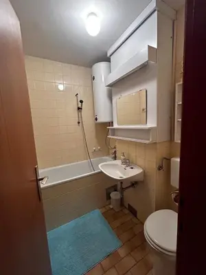 a bathroom with a sink and a toilet and a tub at Apartma Giorgo in Bovec