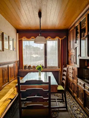 a dining room with a table and a window at Apartma Rustika in Bled