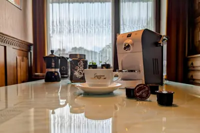 a coffee machine sitting on a counter with a cup at Apartma Rustika in Bled