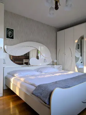 a bedroom with a large white bed in a room at Apartma Rustika in Bled
