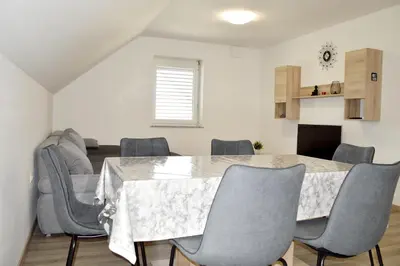 a dining room with a table and chairs at Apartmaji Baznik Čatež in Brežice
