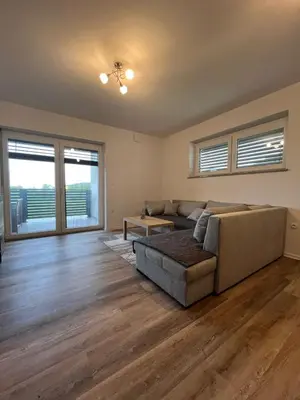 a living room with a couch and a table at Apartmaji Baznik Čatež in Brežice