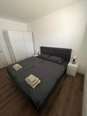 a bedroom with a bed with two towels on it at Apartmaji Baznik Čatež in Brežice