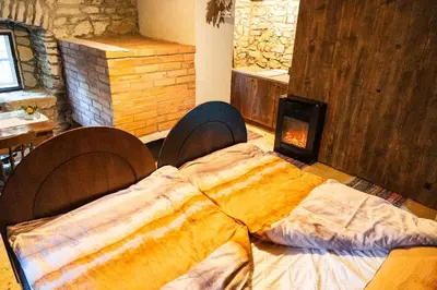 a large bed in a room with a fireplace at Old mill in Štore