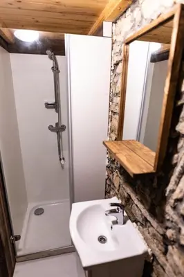 a bathroom with a sink and a shower and a mirror at Old mill in Štore