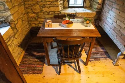 a wooden table with a bowl of fruit on it at Old mill in Štore