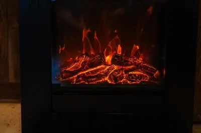 a fire in a fireplace with flames in it at Old mill in Štore