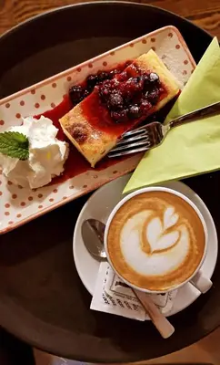 a plate of food with a cup of coffee and cake at Farm Stay Peternelj in Ilirska Bistrica