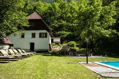 a backyard with a pool and a house at Gorska Vila mountain villa in Soča