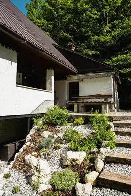 a house with some stairs next to a building at Gorska Vila mountain villa in Soča