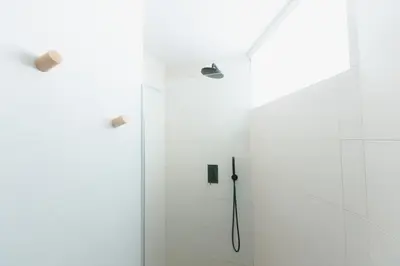 a bathroom with a shower with a black shower head at Gatsby's Place in Ljubljana