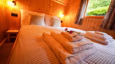 a bedroom with a bed with towels on it at Glamping Avantura- a natural getaway by the Kolpa River in Kostel