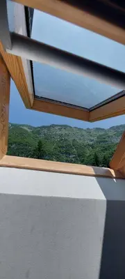 a window on a boat with a view of trees at Dom dr Klementa Juga v Lepeni in Soča