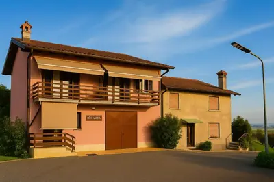 a house with a balcony on a street at Hiša Vanda in Dobrovo