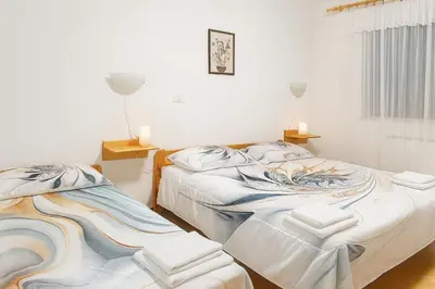 two beds sitting next to each other in a room at Hiša Vanda in Dobrovo