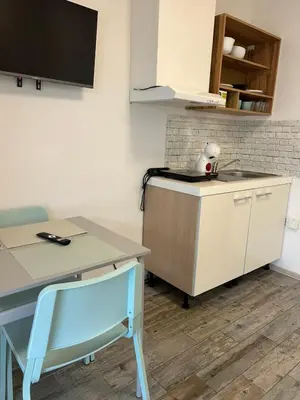 a kitchen with a desk and a table and a table and chair at Apartman min & Ljubljana in Ljubljana
