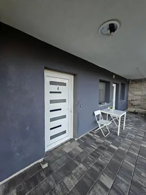 a room with a white door and a table at Apartman min & Ljubljana in Ljubljana