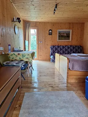 a bedroom with a bed and a table in a room at Hiška Jureš in Ljutomer