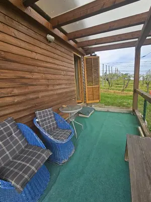 a patio with chairs and a table on a deck at Hiška Jureš in Ljutomer