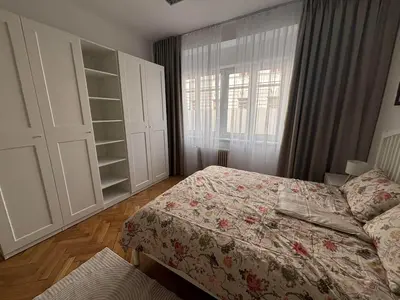 a bedroom with a bed and a window at Trina apartment in the city centre in Ljubljana