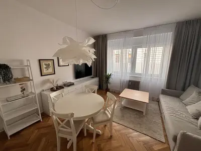 a living room with a table and a couch at Trina apartment in the city centre in Ljubljana