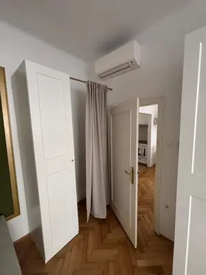 a white room with a door and a hallway at Trina apartment in the city centre in Ljubljana