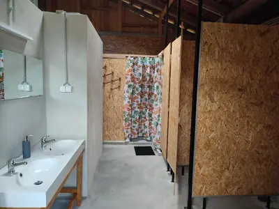 a bathroom with two sinks and a shower at Rustic glamping on a farm in Radovljica
