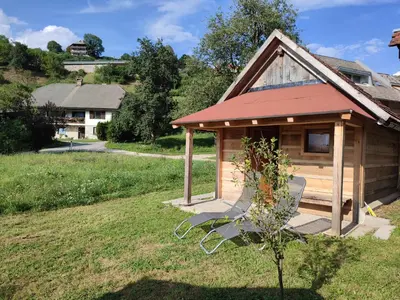 a house with a gazebo in a yard at Rustic glamping on a farm in Radovljica