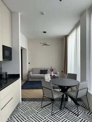 a kitchen and living room with a table and chairs at Soho Boutique apartments in Ljubljana