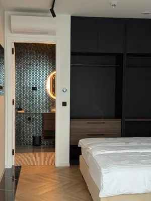 a bedroom with a bed and a black wall at Soho Boutique apartments in Ljubljana