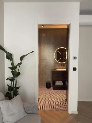 a door leading into a bathroom with a mirror at Soho Boutique apartments in Ljubljana