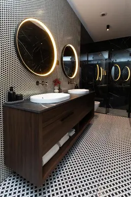a bathroom with two sinks and two mirrors on the wall at Soho Boutique apartments in Ljubljana