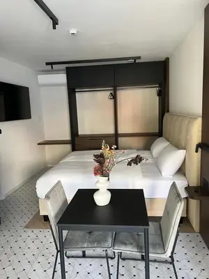 a bedroom with a bed and a table with a vase on it at Soho Boutique apartments in Ljubljana