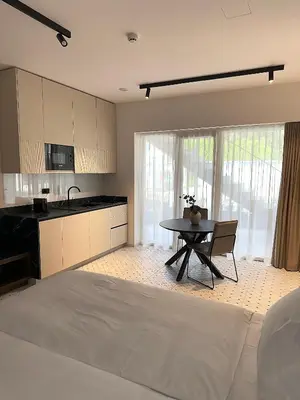 a kitchen and dining room with a table in a room at Soho Boutique apartments in Ljubljana
