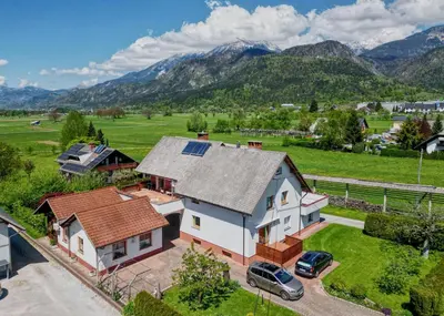 an aerial view of a house with mountains in the background at Apartment Zupan in Begunje na Gorenjskem