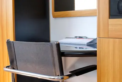 a chair with a desk in a room at Apartment Zupan in Begunje na Gorenjskem