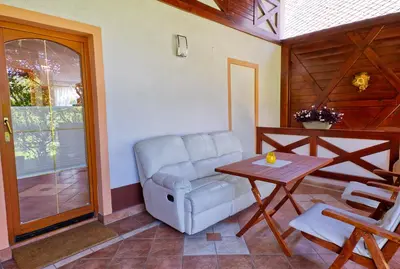 a living room with a chair and a table at Apartment Zupan in Begunje na Gorenjskem