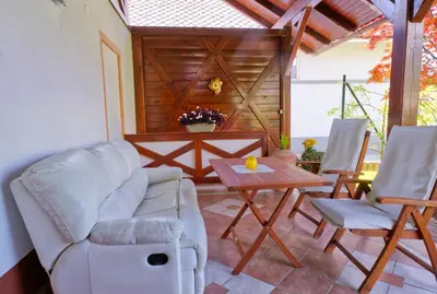 a living room with a couch and a table and chairs at Apartment Zupan in Begunje na Gorenjskem
