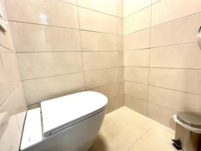 a bathroom with a white toilet in a room at Rookos rooms in Ljubljana