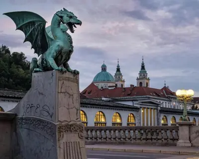 a statue of a dragon in front of a building at Rookos rooms in Ljubljana