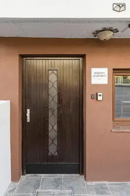 a brown door on a building with a sign on it at Serenity Apartment Bled - New, Stylish, Near Lake in Bled