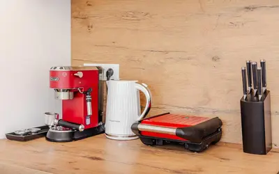 a red coffee maker sitting on top of a counter at Skalja Apartment in Bovec
