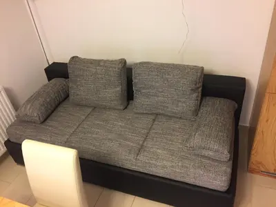 a couch with two pillows in a room at Apartment HB Moravske Toplice in Moravske Toplice