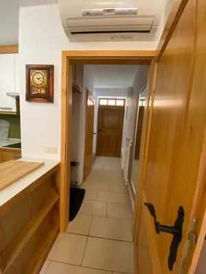 a hallway leading into a kitchen with a clock on the ceiling at Apartment HB Moravske Toplice in Moravske Toplice