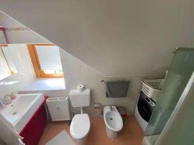 a small bathroom with a toilet and a sink at Apartment HB Moravske Toplice in Moravske Toplice