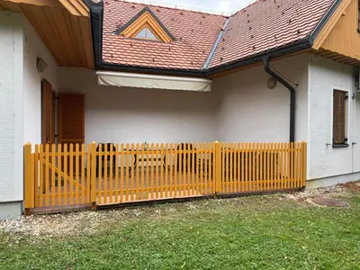 a wooden fence in front of a house at Apartment HB Moravske Toplice in Moravske Toplice