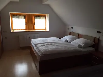 a bedroom with a large bed with a window at Apartment HB Moravske Toplice in Moravske Toplice