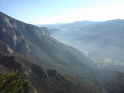 a view of a valley from a mountain at Deer Land Photo Apartment in Kočevska Reka