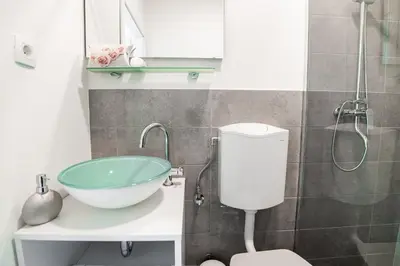a bathroom with a sink and a toilet at Oxford Apartments in Ljubljana